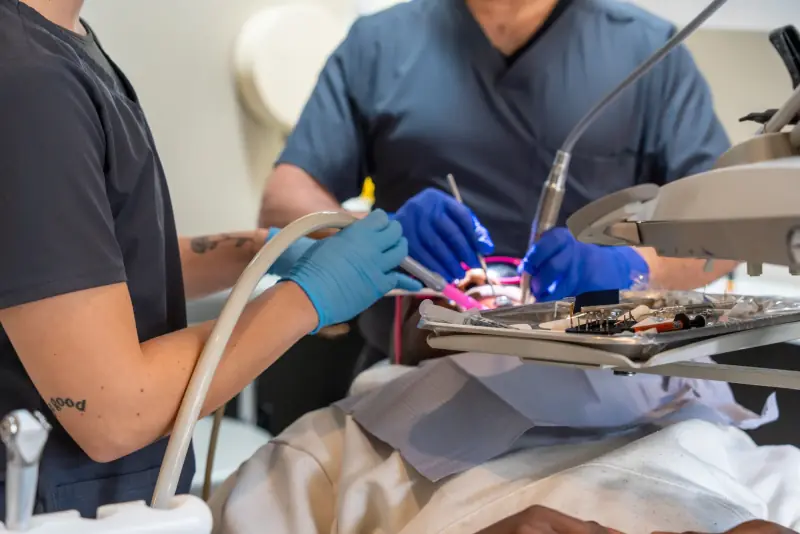 A dentist and dental assistant providing treatment at My New Teeth in Cookstown