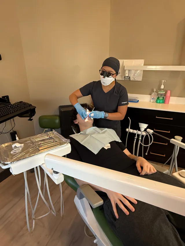 Dental hygienist providing a professional cleaning in a Cookstown treatment room