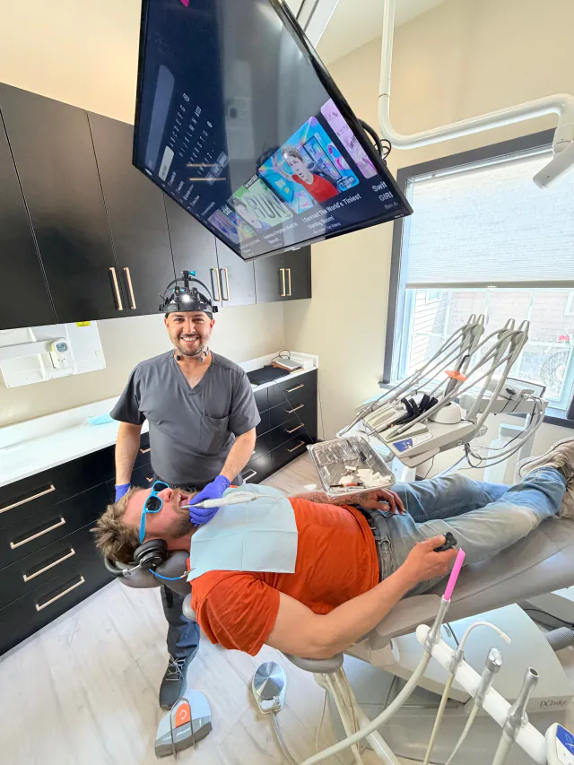 Dentist caring for a relaxed patient in a modern treatment room