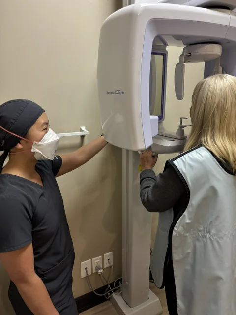 Dental assistant positioning a patient for a panoramic X-ray