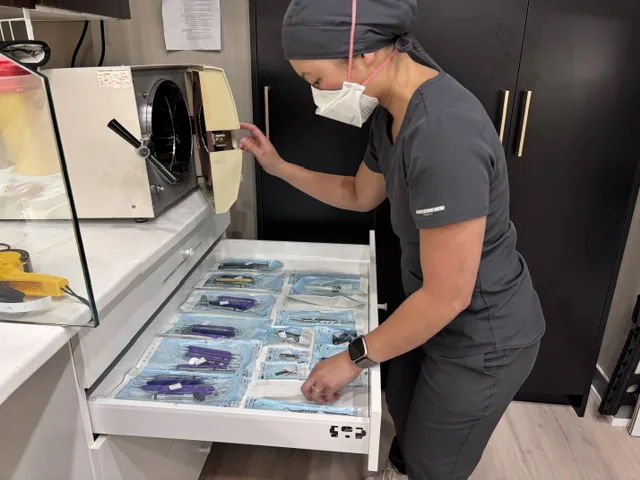 Dental team member preparing sealed sterile instruments