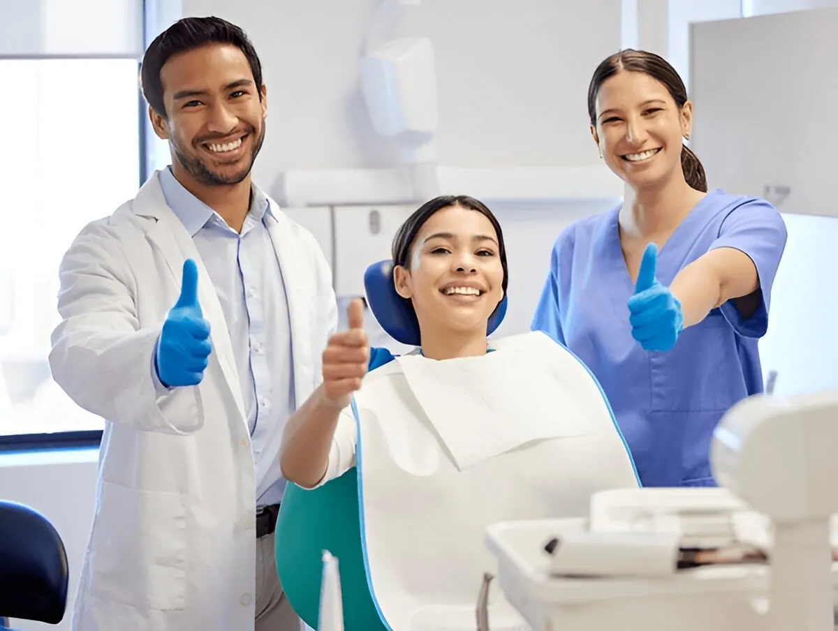 Patient with two members of a dental team