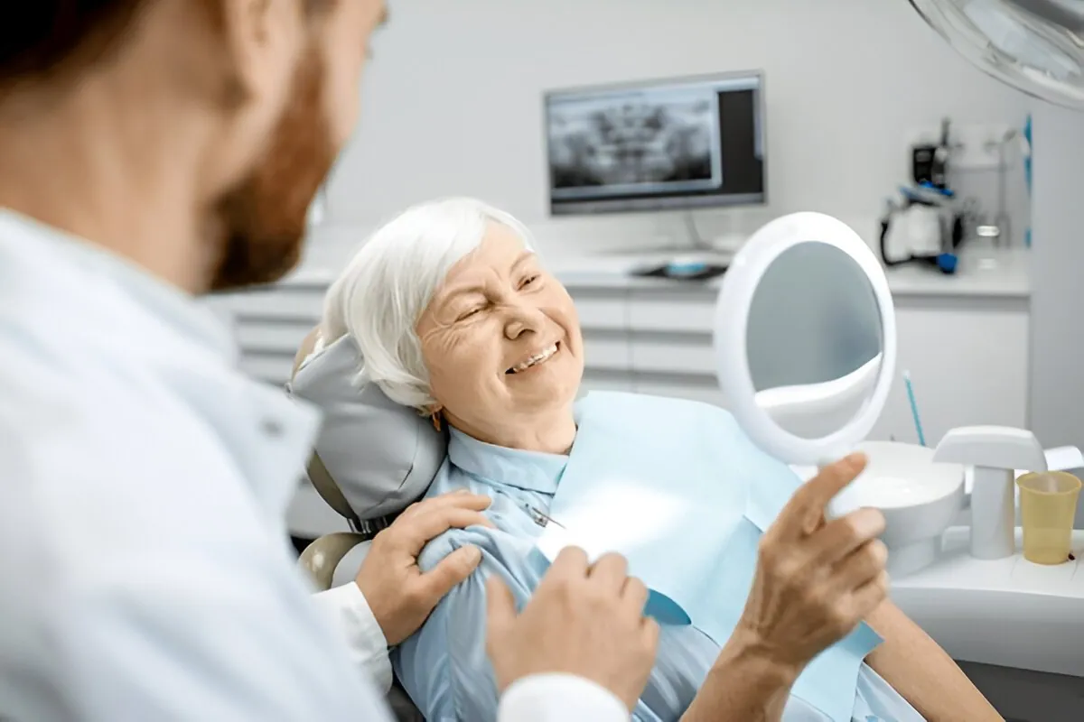Older patient speaking with a dental professional