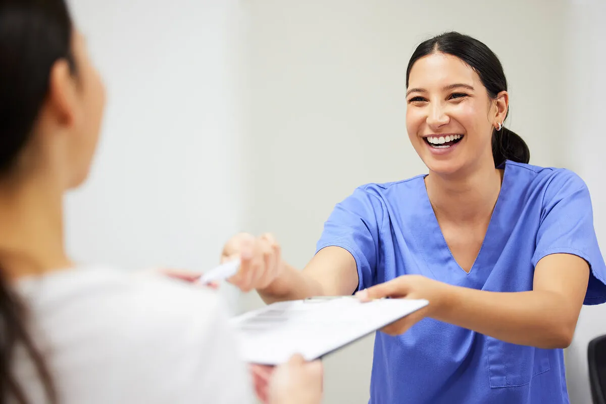 Dental team member reviewing care information with a patient